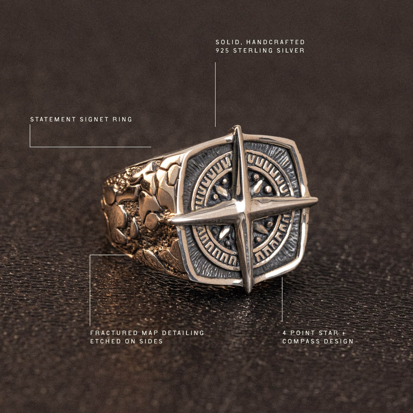 Sterling silver statement signet ring with four-point star compass design and etched map detailing on the sides.