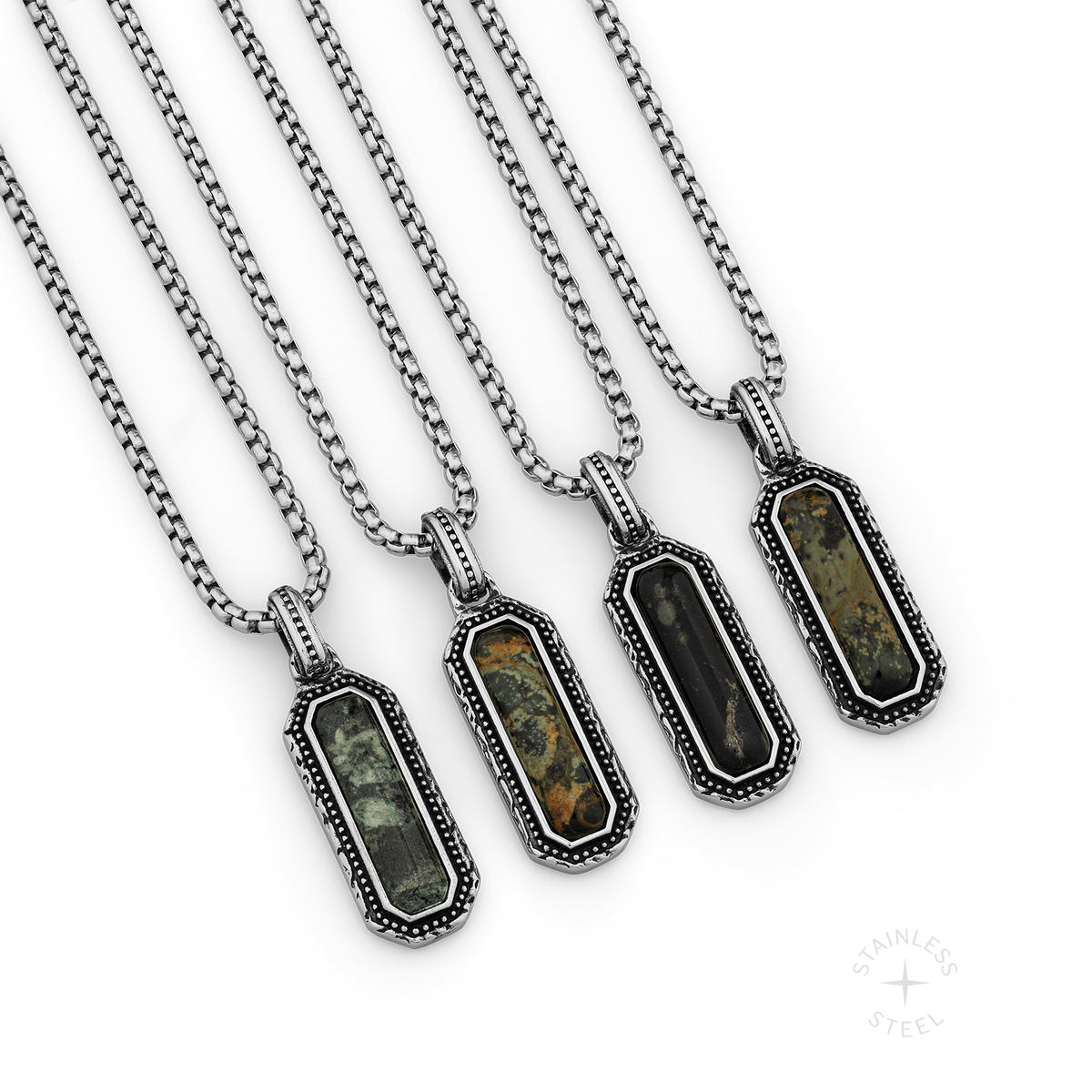 Four stainless steel pendant necklaces with kambaba jasper stones in ornate rectangular settings.