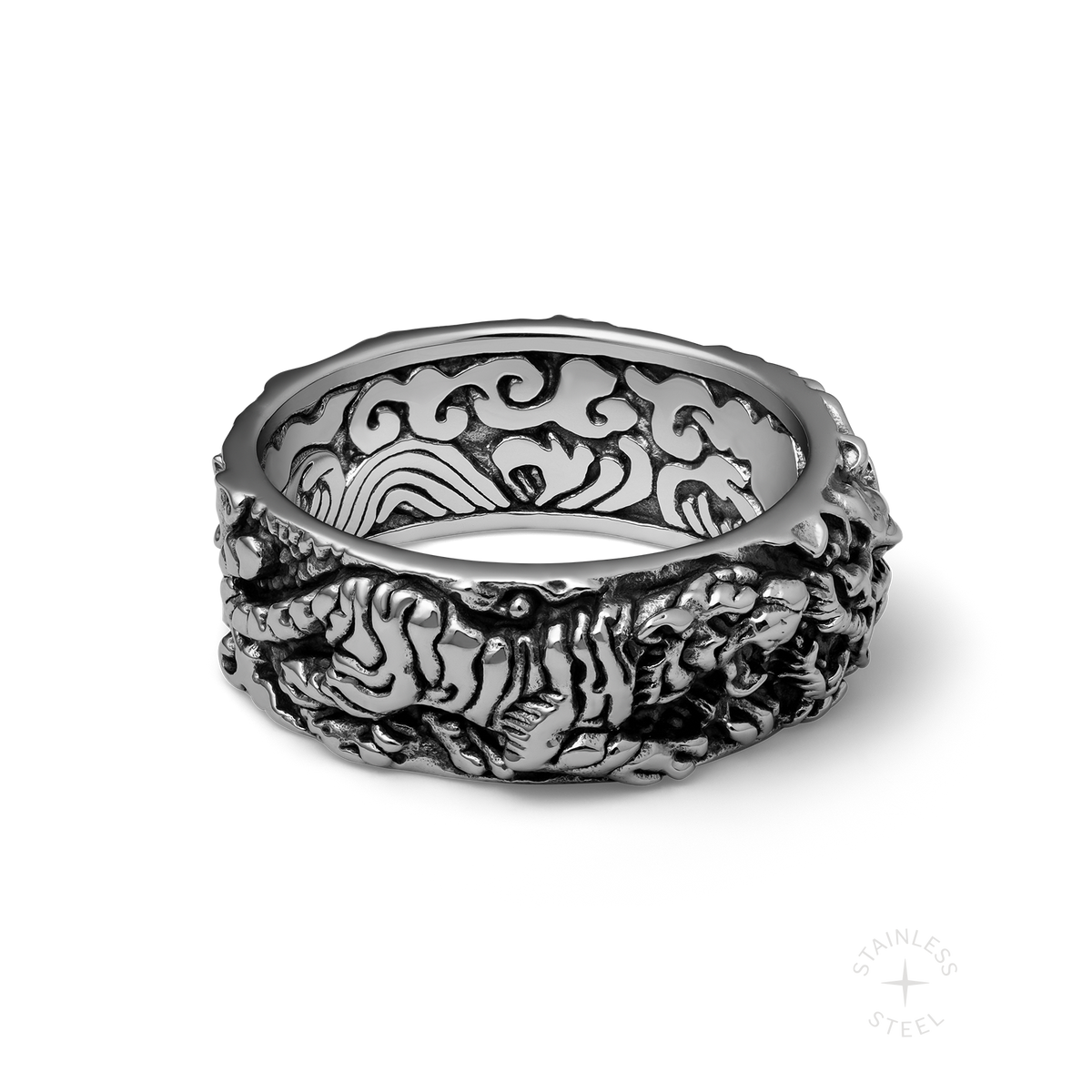 Silver-toned band ring with textured brain and skull design, ornate scrollwork visible on inner band.