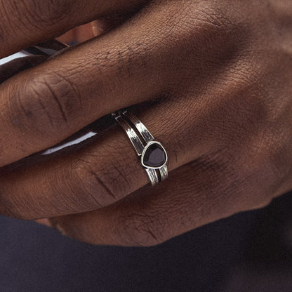 hand wearing sterling silver black onyx black lotus signet ring