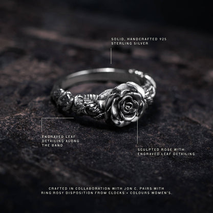 Sterling silver ring featuring a sculptured rose with engraved leaf detailing along the band.