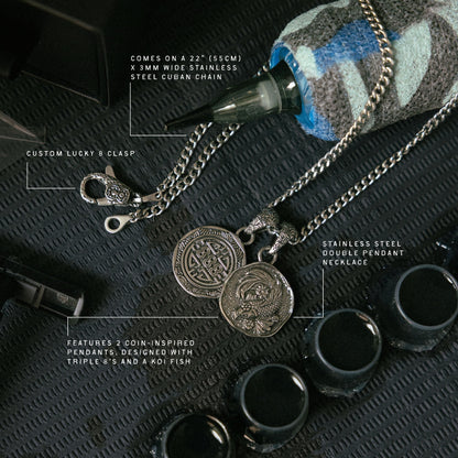 Stainless steel double pendant necklace with coin-inspired charms and 22" Cuban chain, displayed with lucky 8 clasp and black