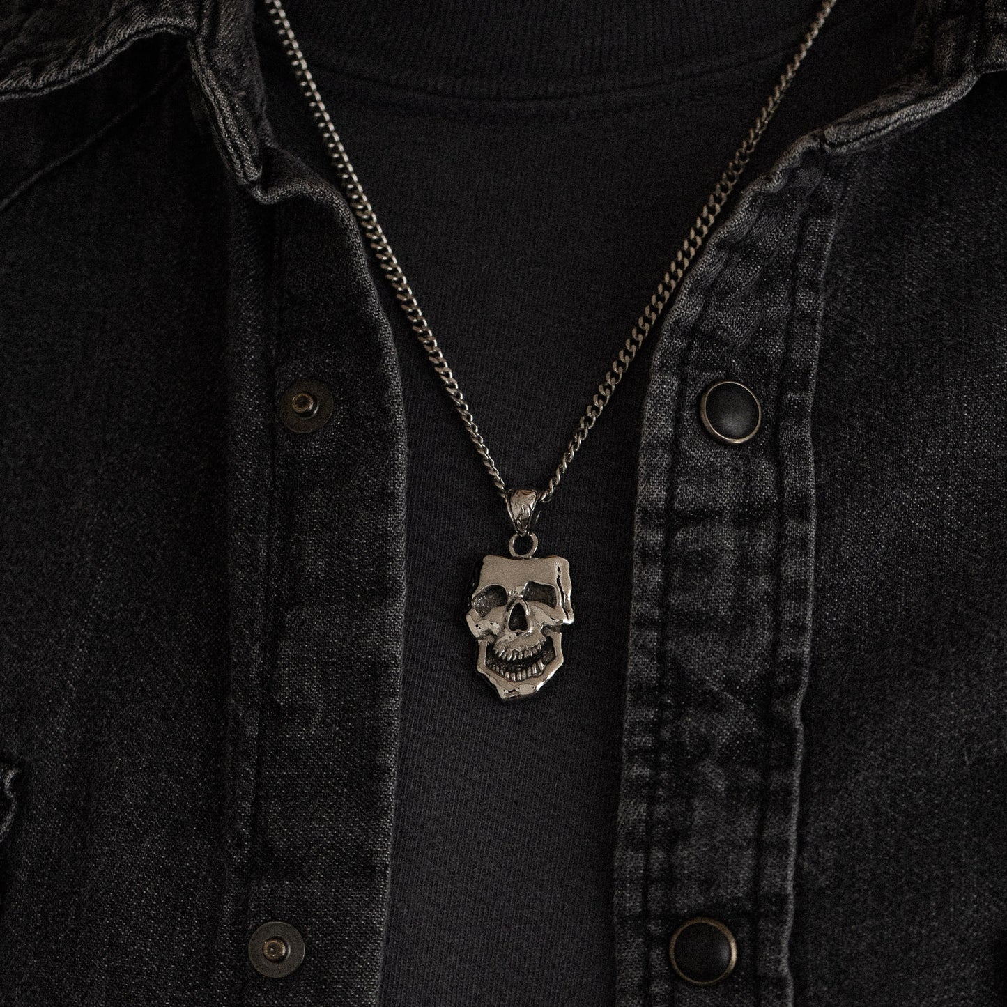 stainless steel pendant with double sided skull design inspired by comedy and tragedy masks