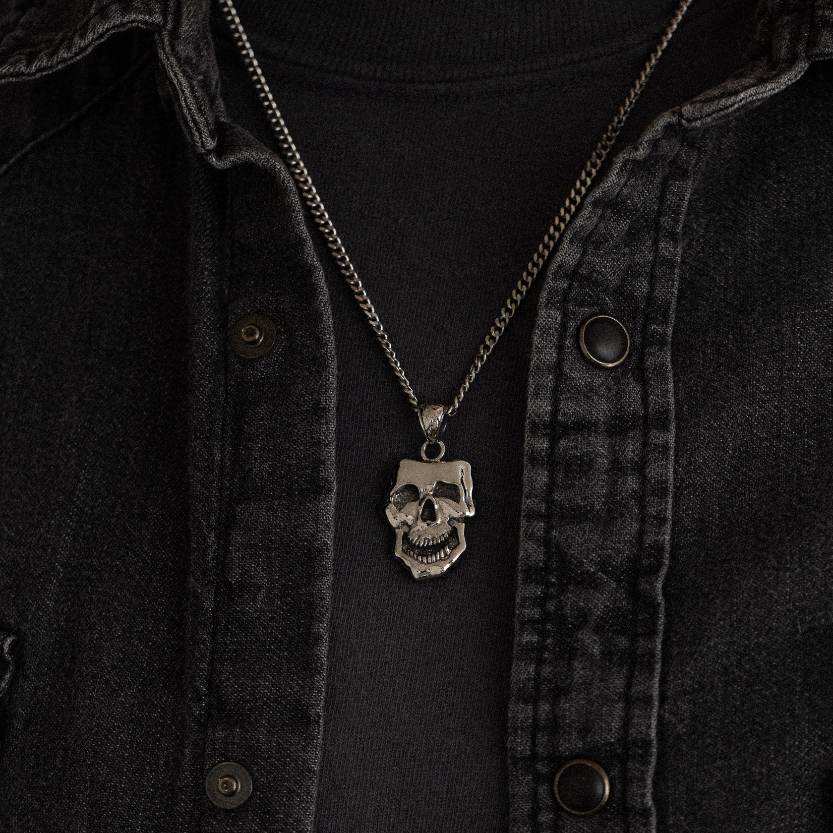 stainless steel pendant with double sided skull design inspired by comedy and tragedy masks