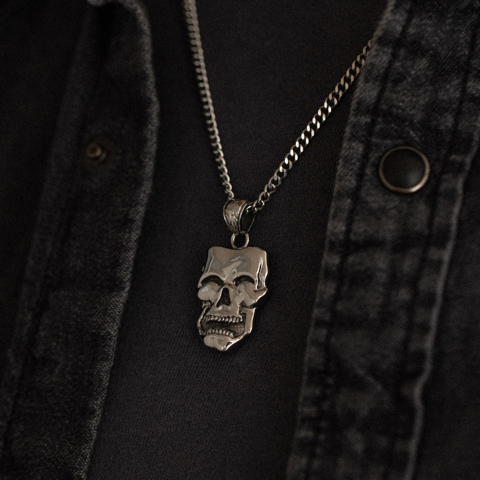 stainless steel pendant with double sided skull design inspired by comedy and tragedy masks