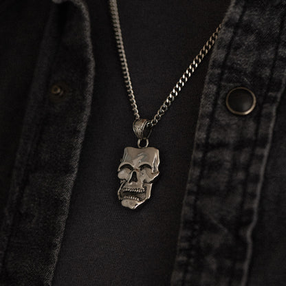 stainless steel pendant with double sided skull design inspired by comedy and tragedy masks