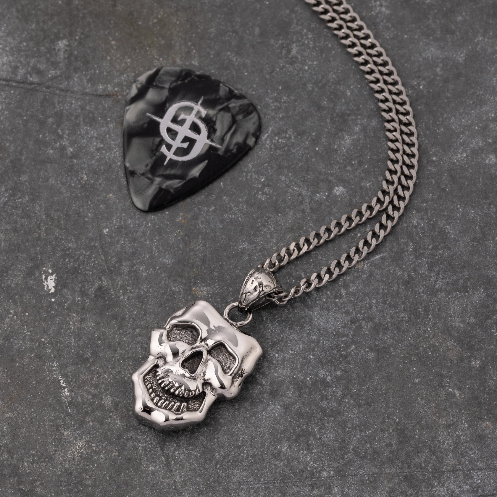 stainless steel pendant with double sided skull design inspired by comedy and tragedy masks
