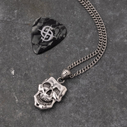 stainless steel pendant with double sided skull design inspired by comedy and tragedy masks