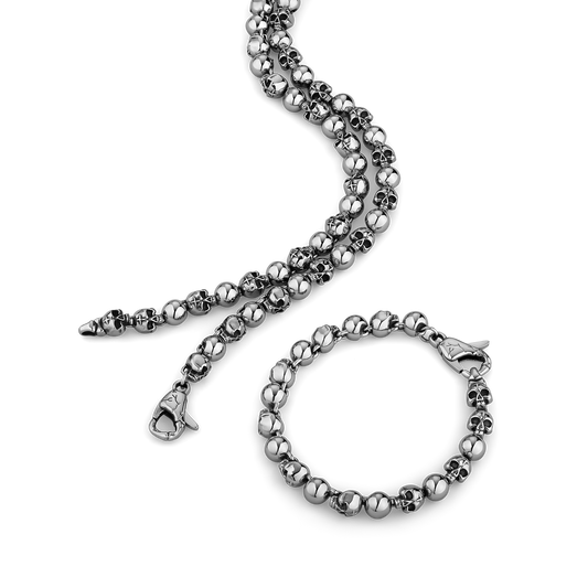 stainless steel beaded necklace and bracelet set on a white background