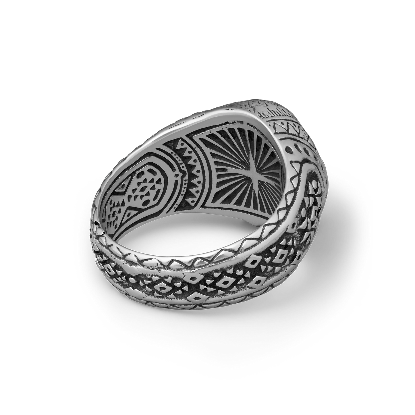 Silver skull ring with intricate patterns on a white background