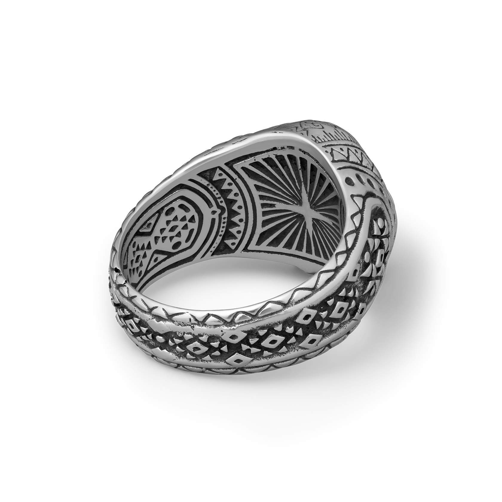 Silver skull ring with intricate patterns on a white background