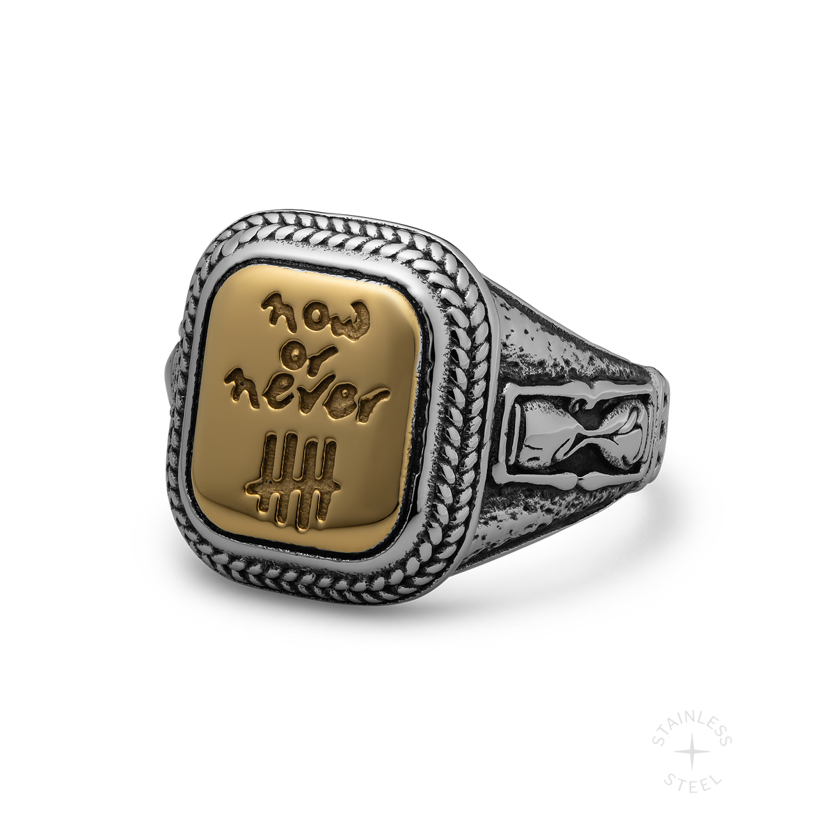 Silver and gold-tone ring with braided border and rectangular face engraved with "Now or Never" text and tally marks.