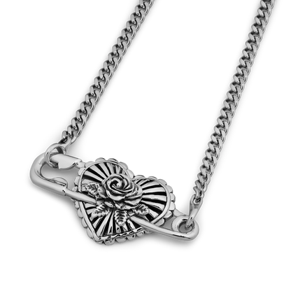 Silver-toned pendant necklace featuring a decorative rose and fan design with curb chain.
