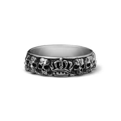 Silver band ring with skulls and crown motif around the exterior surface.