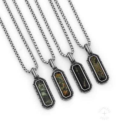 Four stainless steel pendant necklaces with kambaba jasper stones in ornate rectangular settings.