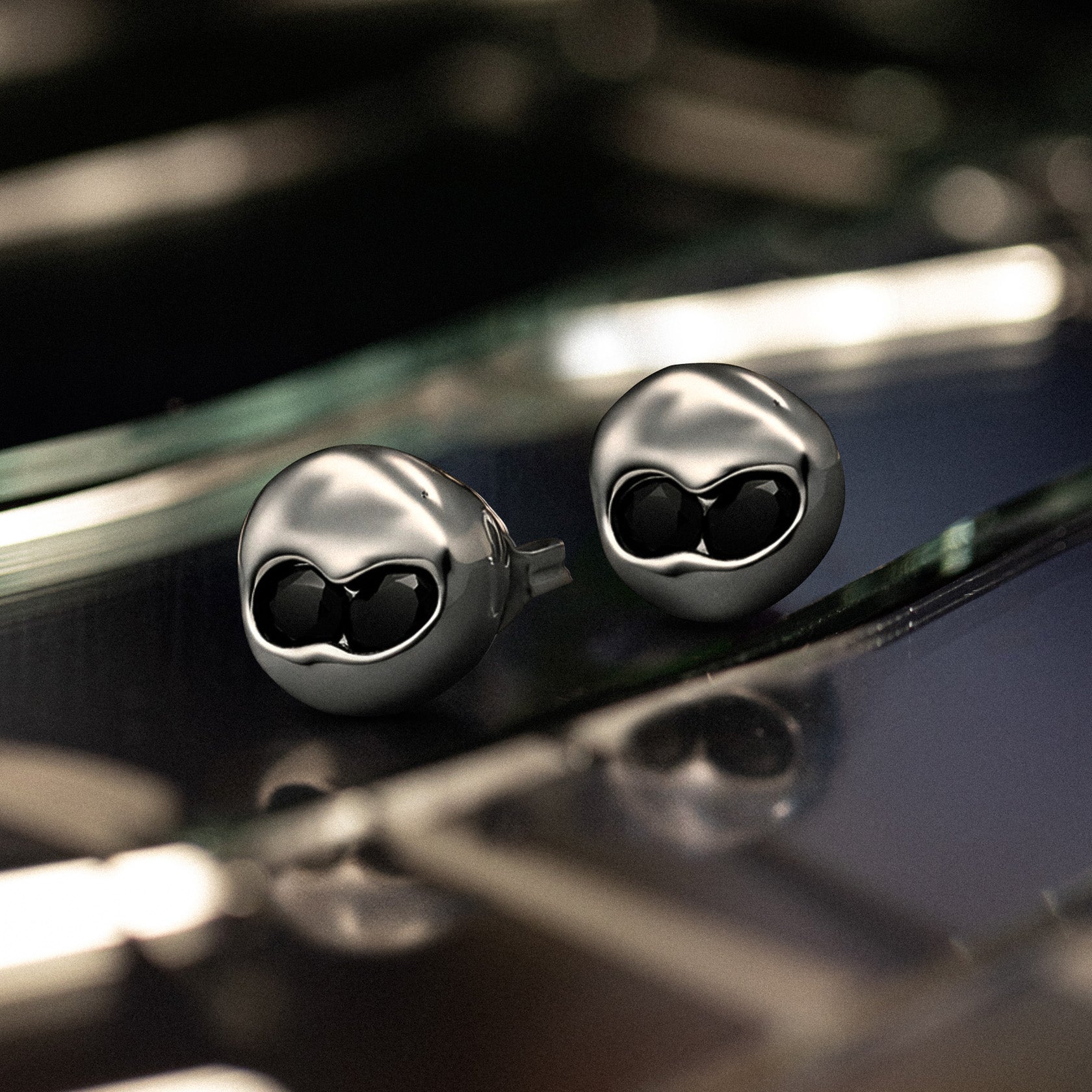 set of two Sterling silver stud earrings with sunken Black Onyx stones set in a rounded, polished form